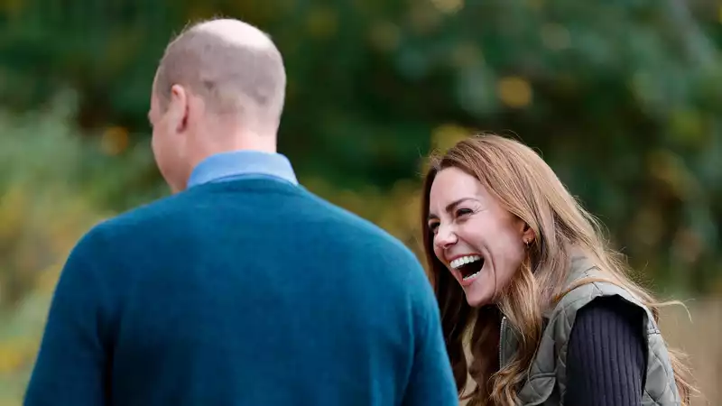 Kate Middleton laughing happily with Prince William at a scouting event.