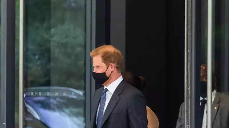 Prince Harry with a briefcase engraved "Archie's Papa"