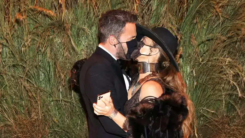 Jennifer Lopez and Ben Affleck share a passionate masked kiss at the Met Gala.