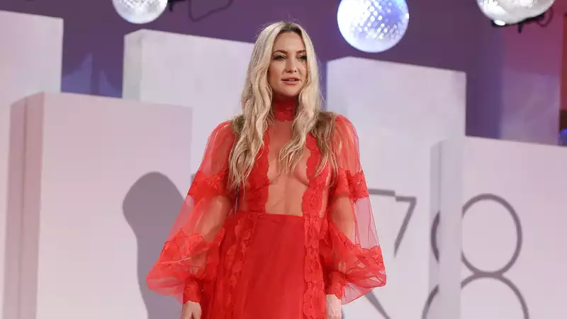 Kate Hudson turns heads in a sheer-accented red gown at the Venice International Film Festival.