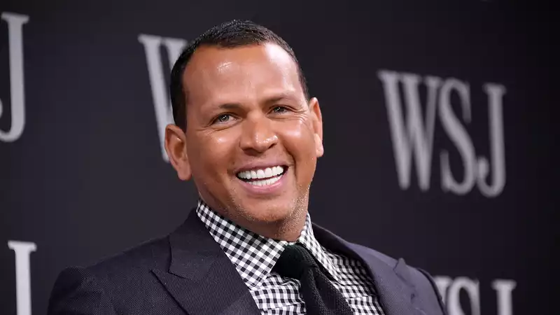 Alex Rodriguez poses in the red Porsche he gave Jennifer Lopez for her 50th birthday.