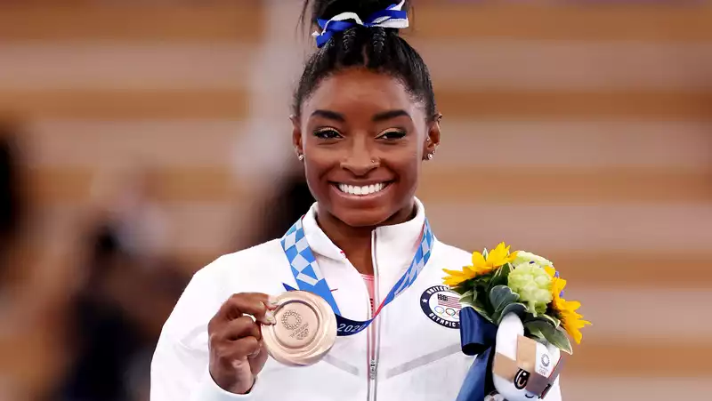 Simone Biles in a tie-dye bikini.