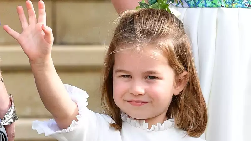 Prince William and Kate Middleton hold a butterfly in an undated photo of Princess Charlotte.