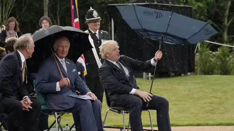 Prince Charles, no reaction at all to Boris Johnson's umbrella.