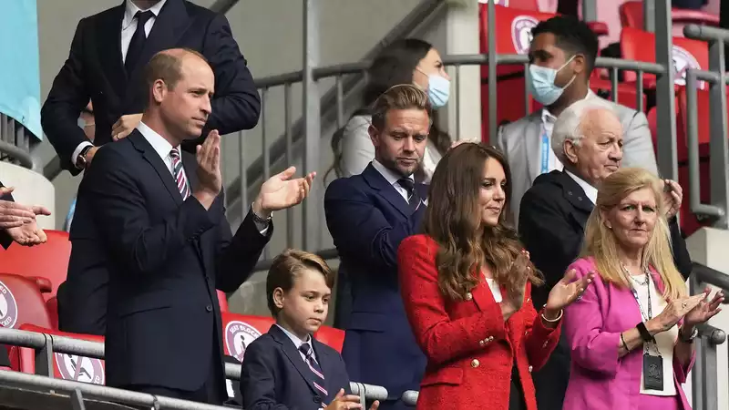 Prince George, Prince William's mini-me in a suit at a soccer game.