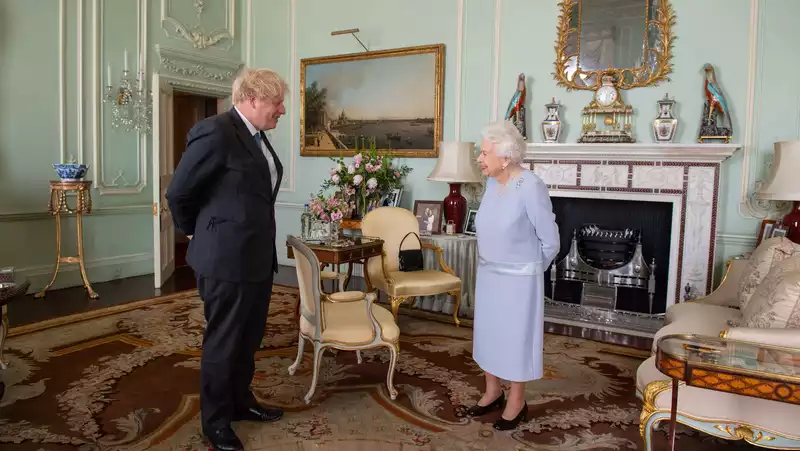 Rare Photos of the Queen, Meghan and Harry on Display at Buckingham Palace