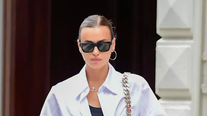 Irina Shayk coordinates her LBD with an oversized shirt and Burberry sandals