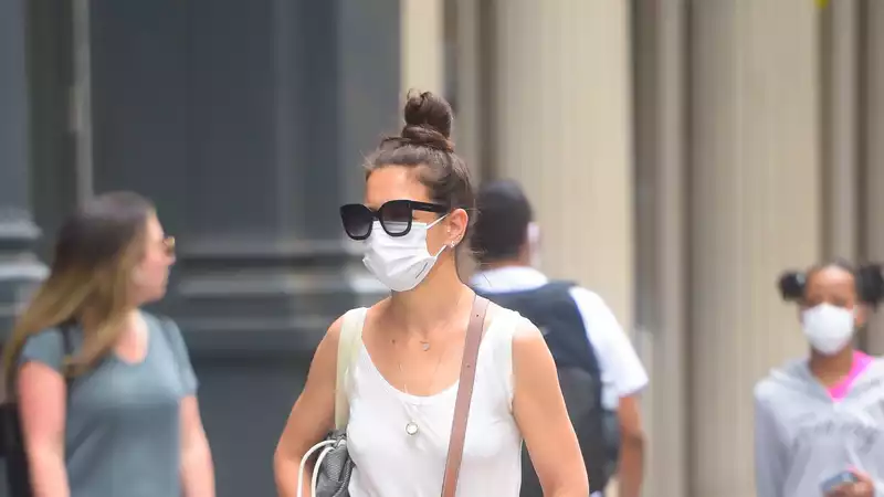 Katie Holmes wearing baggy blue jeans and relaxed white tank in NYC