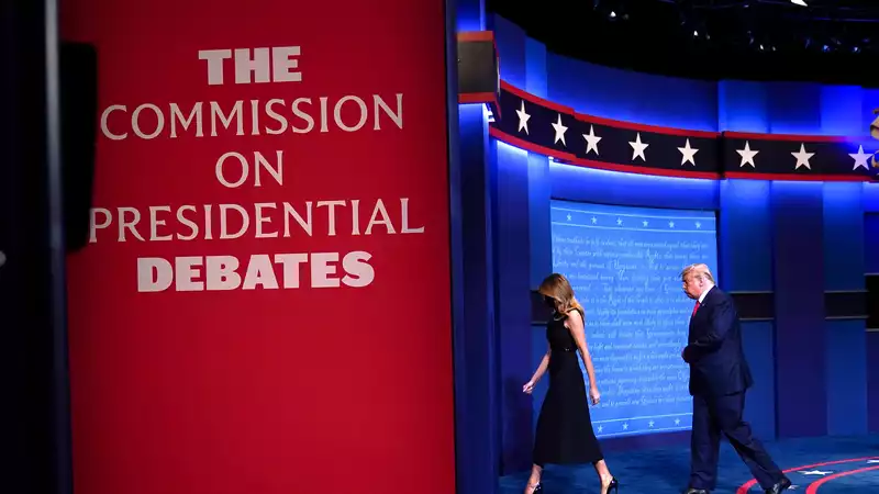 Melania Trump takes her hands off Donald Trump after the debate.