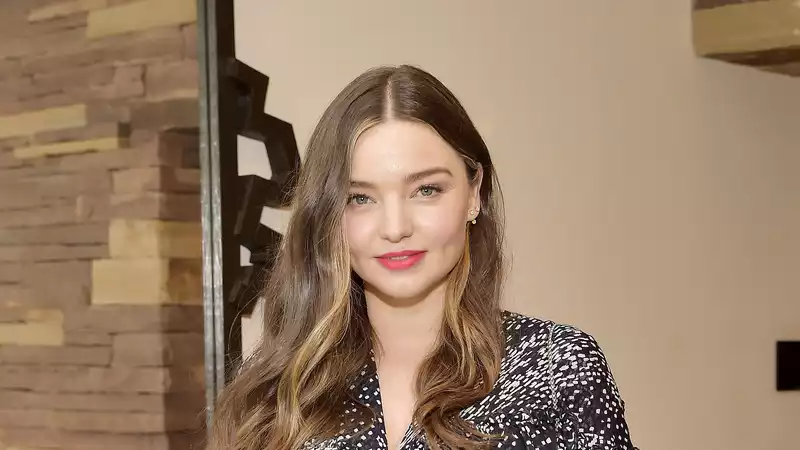 Miranda Kerr says she is "very happy" with her new parents, Orlando Bloom and Katy Perry.