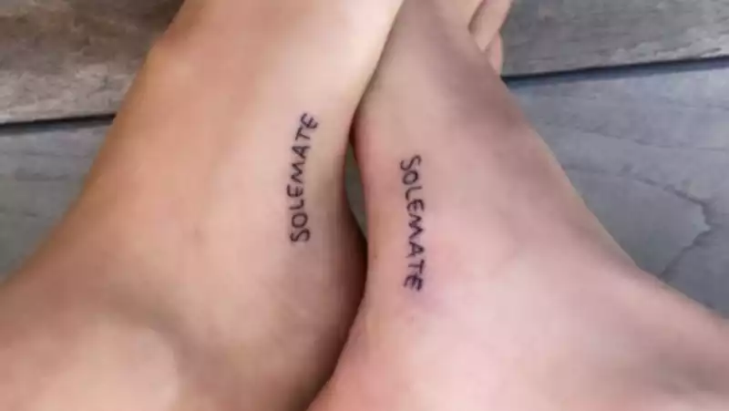 Kaia Gerber and Cara Delevingne with matching "Solemate" tattoos.