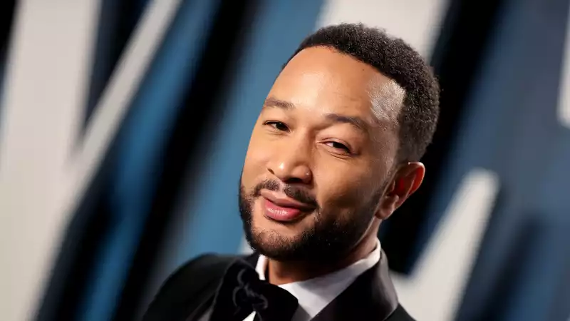 John Legend and son Miles in matching swim shorts and twin shots.