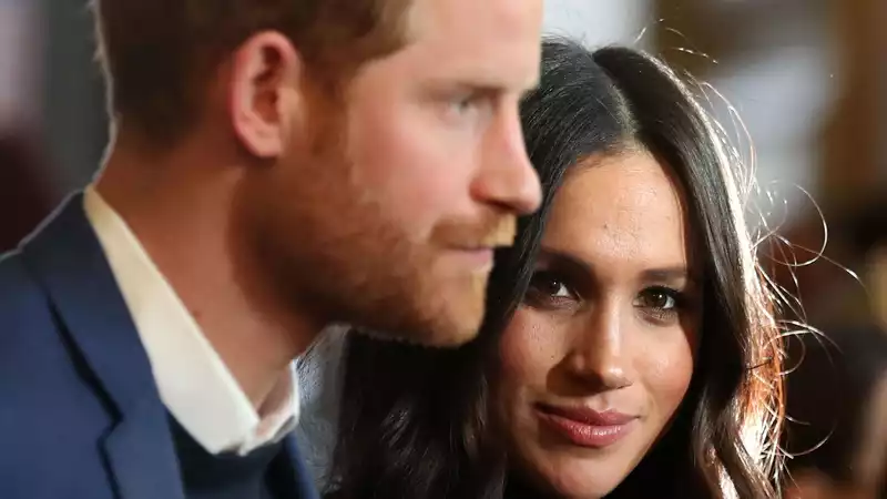 Meghan Markle looks cozy and happy as she steps off a commercial plane.