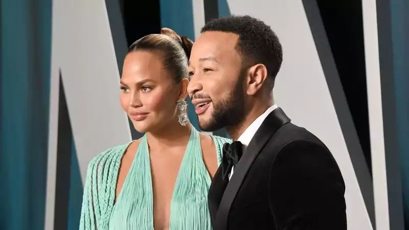 Chrissy Teigen in a mint dress with a thigh-high slit at the Academy Awards after-party.