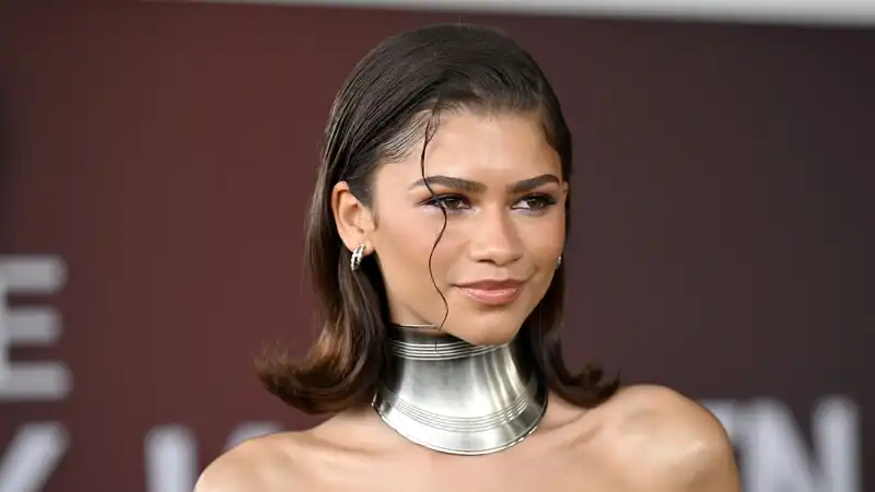 Zendaya bends fashion ties archived in lace corset top and couture denim.