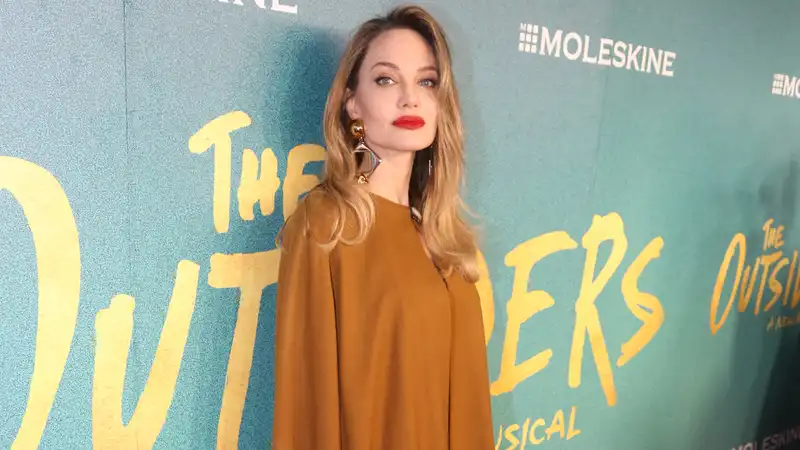 Angelina Jolie in a Golden Goddess Dress at the Broadway Premiere of "The Outsiders"