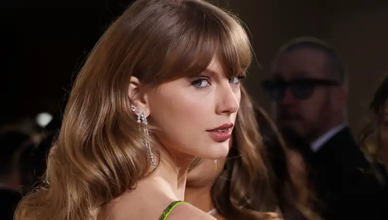 Taylor Swift's charity auction outfit mixes evening gown and $120 necklace