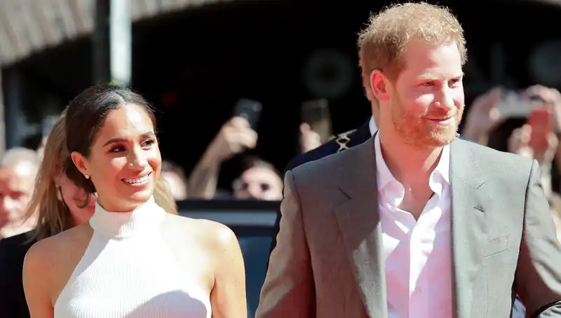 Meghan Markle's outfit is repeated with a white high-neck tank top and pleated pants