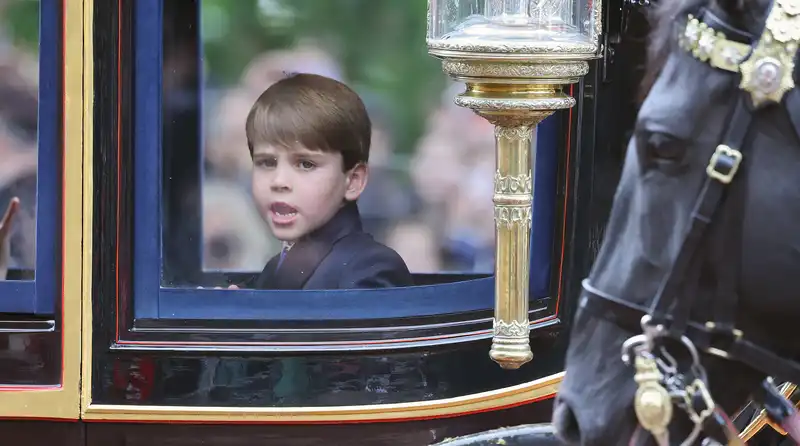 Prince Louis waves at the crowning ceremony