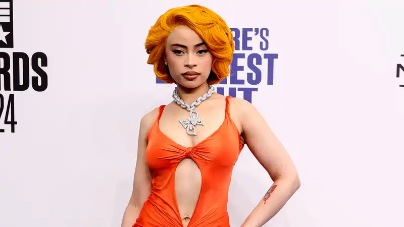 Ice Spice coordinates her hair with a vintage orange Versace dress at the BET Awards