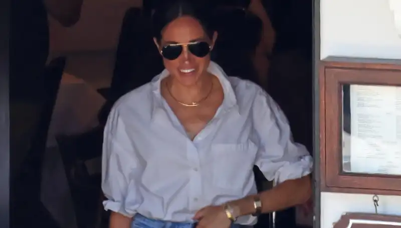 Meghan Markle in jeans and white button-down with a subtle Princess Diana Lady Dior bag