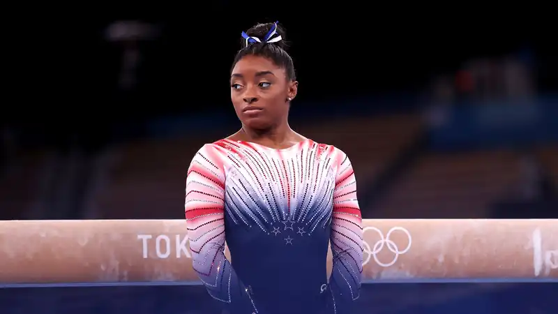 Simone Biles brushes off critics who take issue with her husband Jonathan Owens wearing a gold medal.