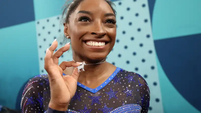 Simone Biles says the GOAT nickname for "haters" is a goat necklace.