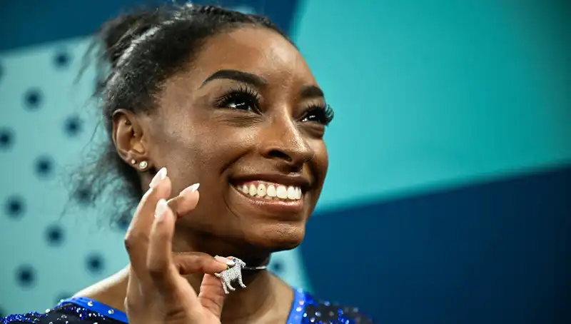 Simone Biles Mates Historic Olympic Gold Medal with Diamond Goat Necklace