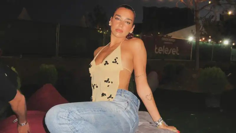 Dua Lipa takes on festival fashion in a sheer top.