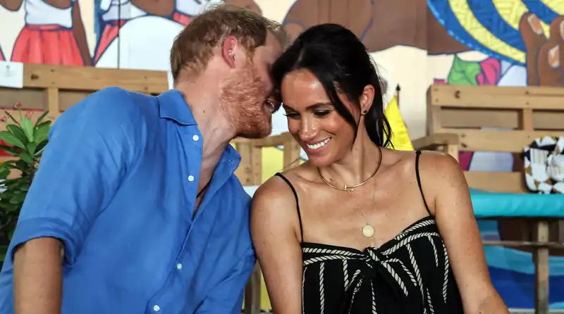 Meghan Markle and Prince Harry play drums during a visit to a school in Colombia