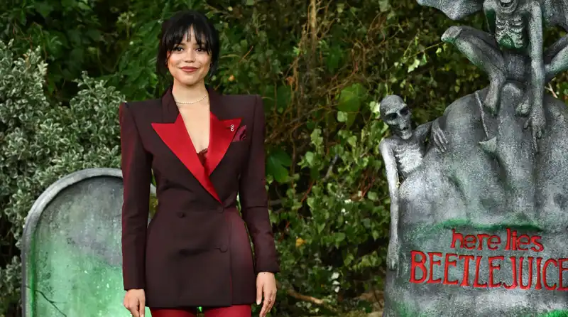 Jenna Ortega Honors Michael Keaton's Iconic “Beetlejuice” Tuxedo in Chic Blazer and Blood Red Platforms