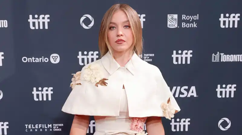 Sydney Sweeney in an “understated” red carpet look in a custom Erdem gown, perfect for fall.