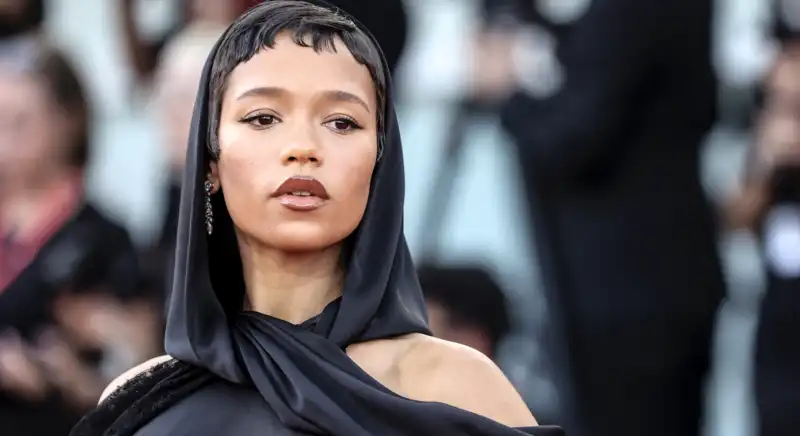 Taylor Russell's black hooded gown makes the butt cutout trend seem very understated