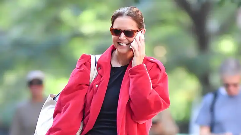 Katie Holmes, classic ballet shoes with a bright red twist on the barn jacket trend.