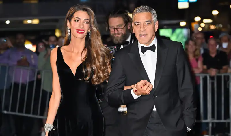 Amal Clooney stuns on the red carpet at Albee's in a Versace gown.