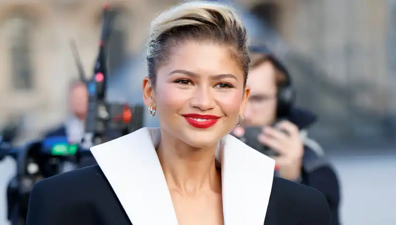 Zendaya in an oversized Louis Vuitton tuxedo blazer and bubble skirt at Paris Fashion Week