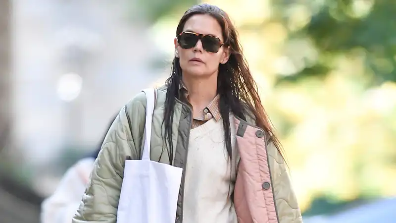 Katie Holmes perfects fall layering in a reversible quilted jacket and red velvet mary janes