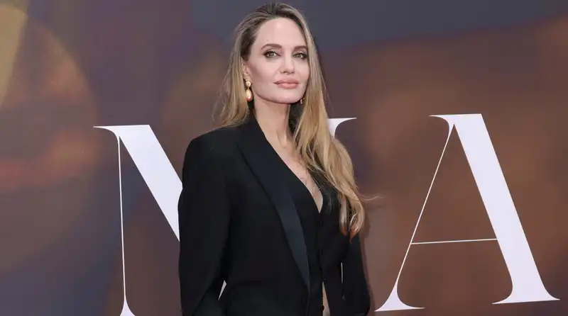 Angelina Jolie shows off her sleek physique in an elevated all-black suit.