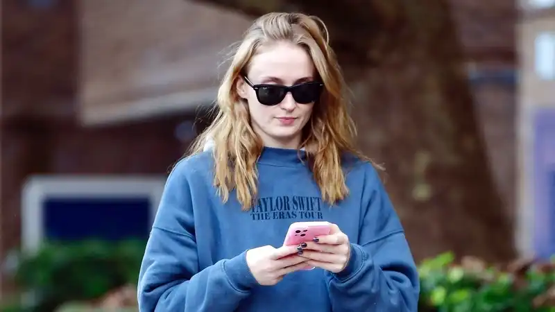 Sophie Turner supports Taylor Swift and Adidas sneakers.