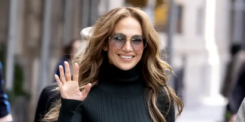 Jennifer Lopez makes pussy ribbon blouses cool again with ballet flats and a Chanel bag