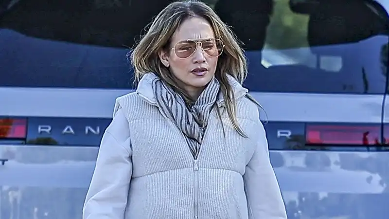 Jennifer Lopez styling Birkin in a winter puffer vest with sweatpants and designer combat boots