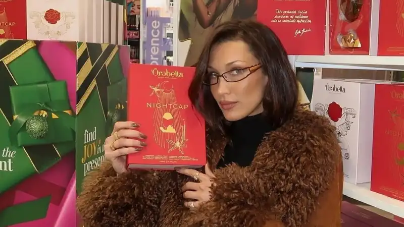 Bella Hadid pairs a Penny Lane coat and sexy librarian glasses for an impromptu photo shoot