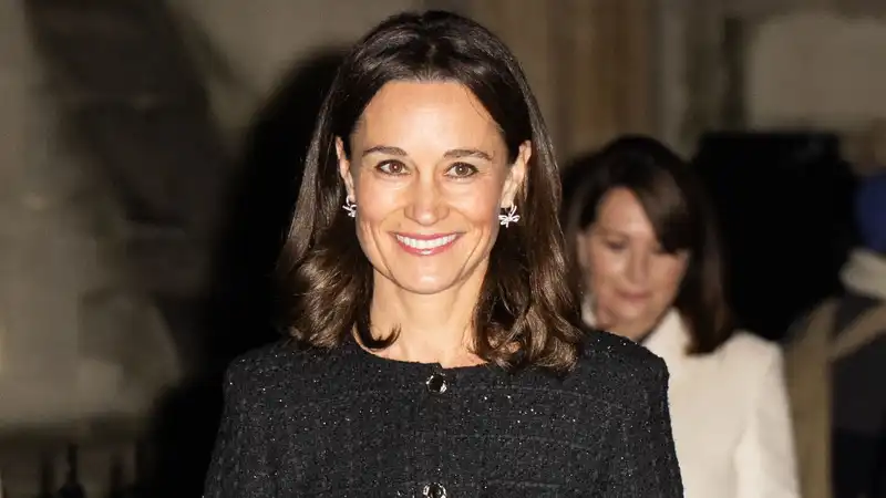 Pippa Middleton shimmers in a sophisticated black coat dress during the Christmas carol event