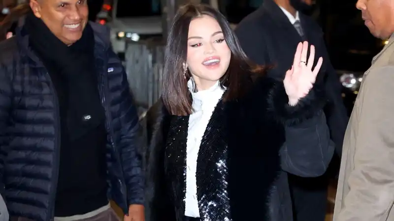 Selena Gomez pairs her brave fur-trimmed winter coat with sequins, ruffles and strappy louboutin pumps