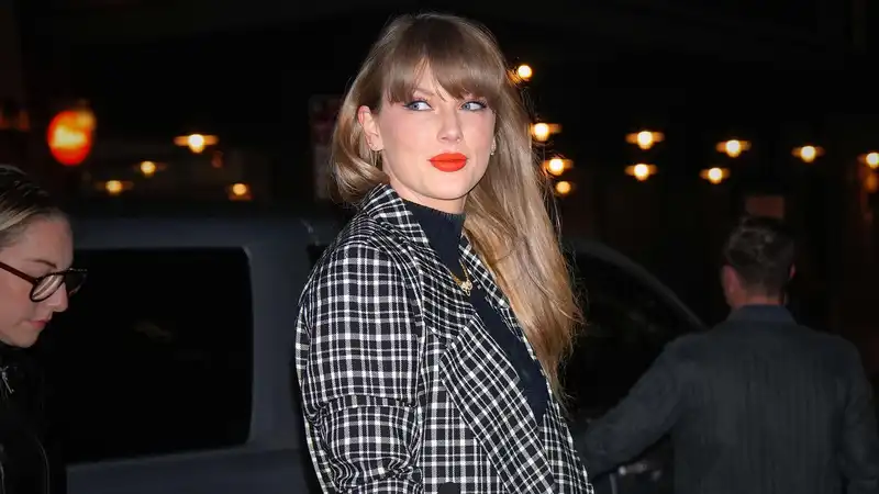 Taylor Swift surprised patients at Children's Hospital by wearing Miu Miu tartan checks with her winter trend boots.