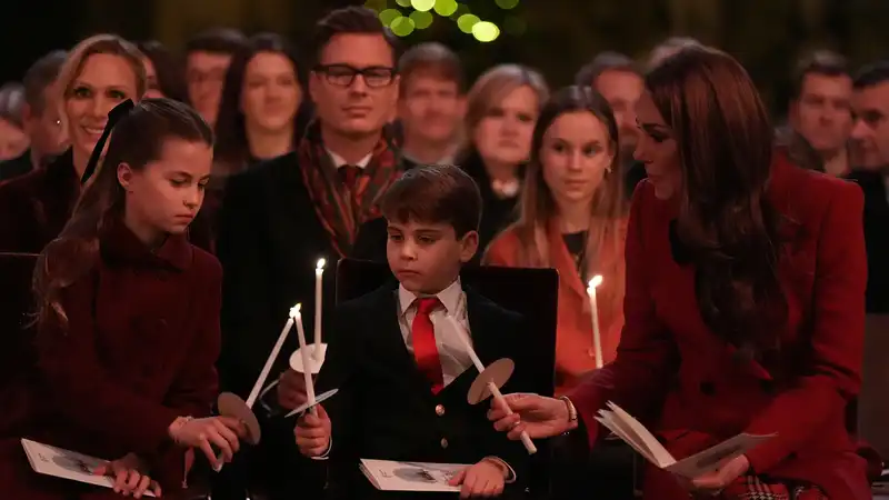 Fans want to know who the dashing “Clark Kent” Royal is who sat behind Princess Kate at the carol concert.