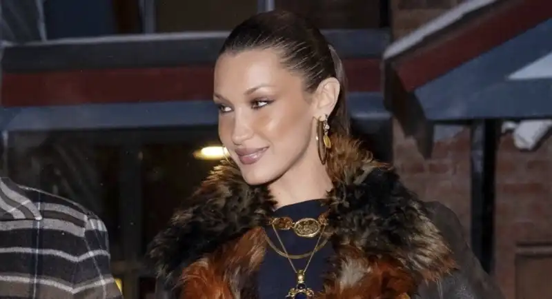 Bella Hadid looks like the First Lady of the rodeo world in her fluffy penny raincoat and patchwork boots